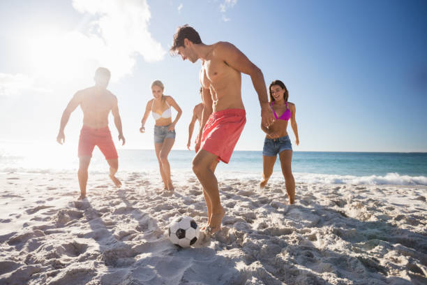 istock Friends playing football 663586714