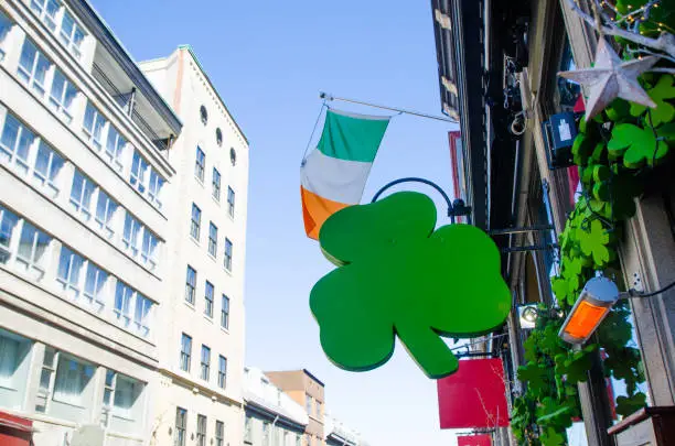 Wooden green clover decoration and Irish flag above an irish pub entrance for St-Patrick's day