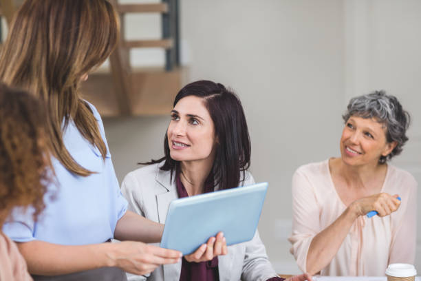 istock Female business colleagues discussing on digital tablet 663597054