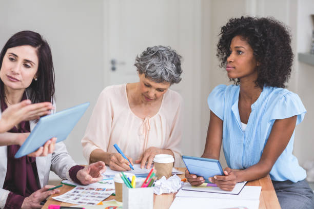 istock Group of interior designers interacting with each other 663598700