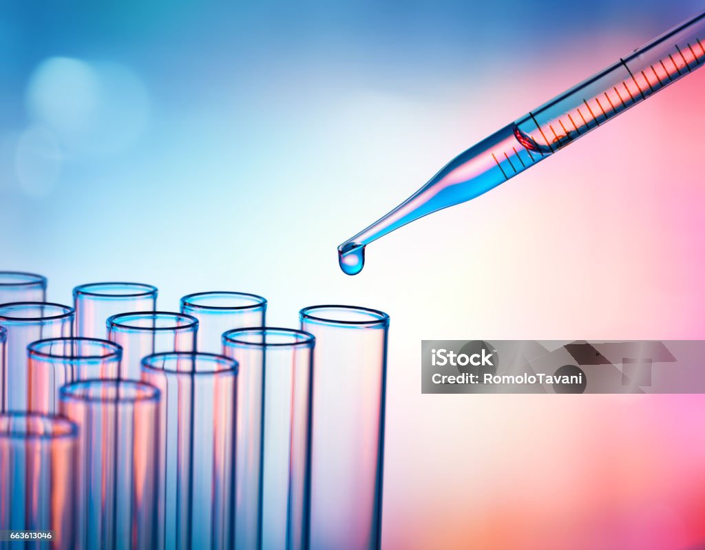 Pipette Dropping A Sample Into A Test Tube - Closeup Test Tubes And Pipette - Research In Laboratory Laboratory Stock Photo