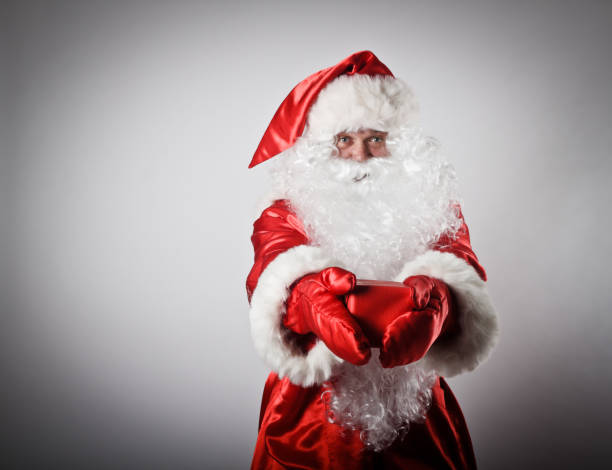 istock Santa Claus is giving Christmas gift 663615268