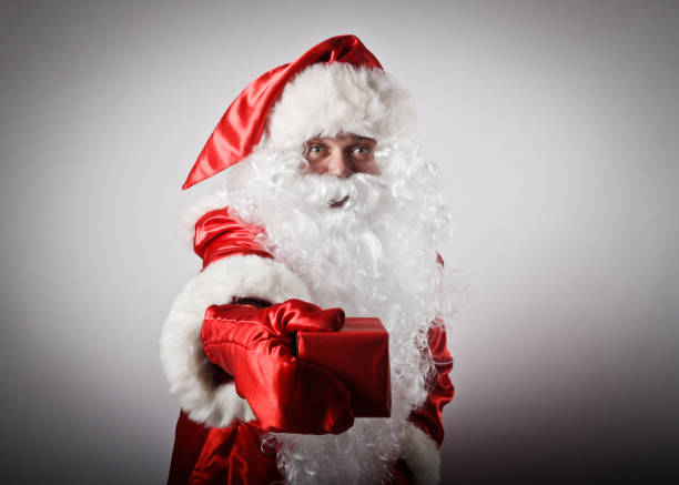 istock Santa Claus is giving Christmas gift 663615310