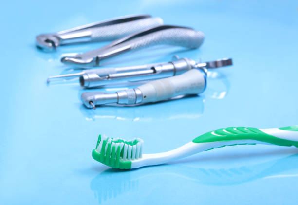 istock dental care toothbrush with dentist tools on mirror background. 663620578