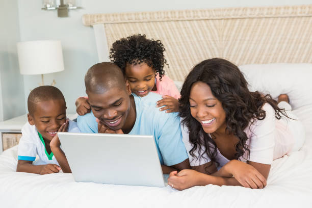 istock Family having fun together in bed 663623304
