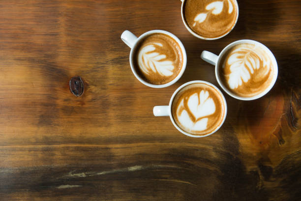 istock Cup of latte with foam art on a saucer with a spoon 663671400