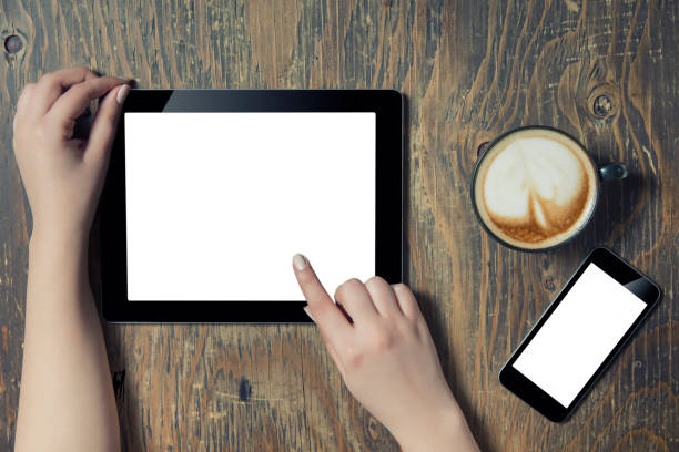 istock Hands holding Digital Tablet in a Coffee Shop 663673022