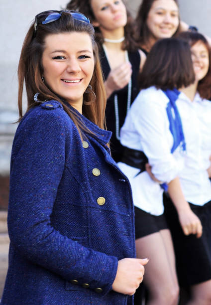 istock college background Successful and friendly student with his friends in the background 663733490