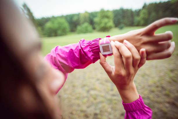 istock Woman using her smartwatch on a hike 663781200