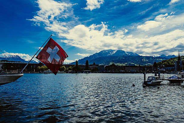 istock Flag In Boat With Mountain In Background 663784555