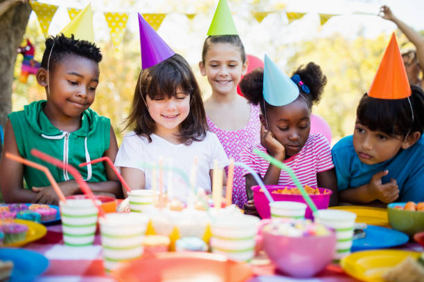 istock Cute children looking candles during a birthday party 663787580