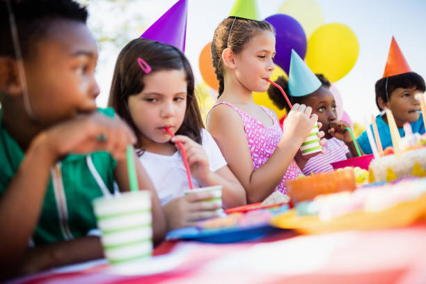 istock Children drinking with a straw during a birthday party 663788018