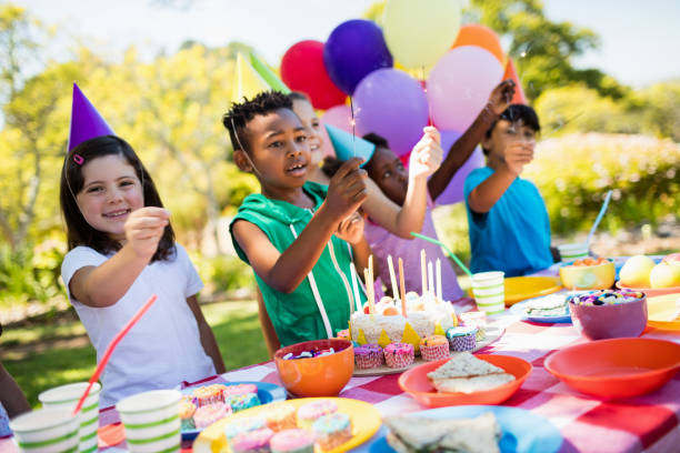 istock Cute children smiling and having fun during a birthday party 663788320