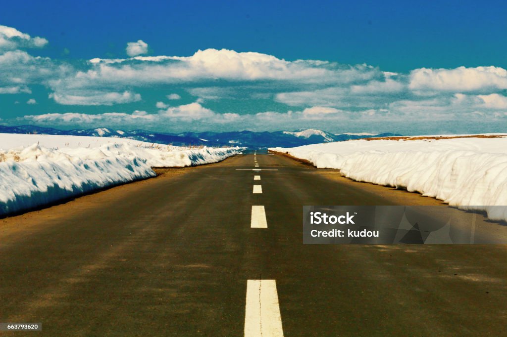 One road of snow melting a road with a thaw Cloud - Sky Stock Photo