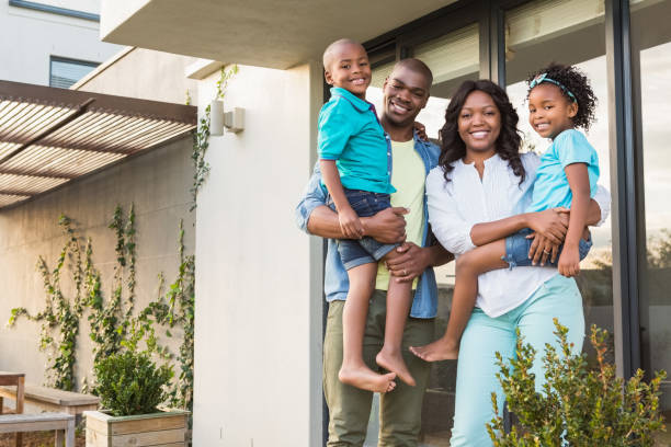 istock Happy family standing in the garden 663800568