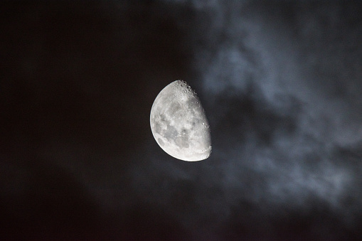 The Moon during it's waxing gibbous phase, eerily surrounded by whispy cloud