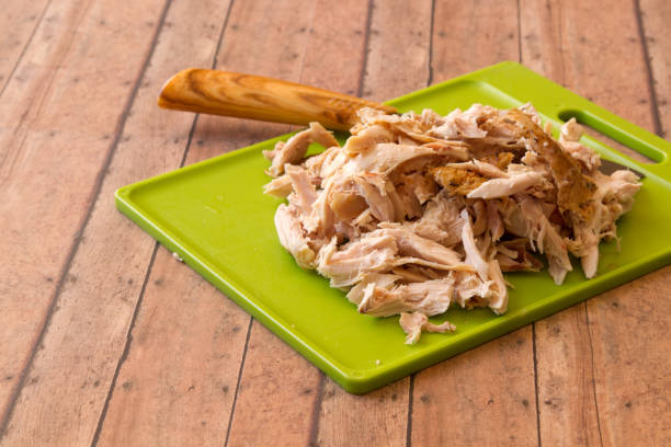 istock Shredded rotisserie chicken on wood plank background 663810172