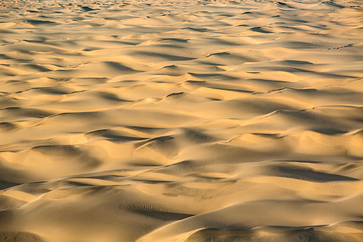 Large sand dunes in a desert from the air