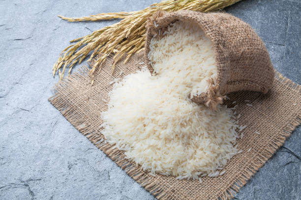 istock thai fragrant jasmine rice in a spoon with gold spike on Sack 663813624