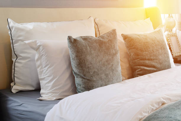 istock bedroom interior design with white and green pillows on white bed 663820466