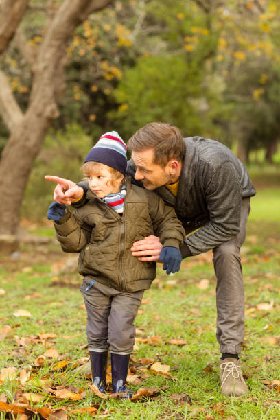 istock Young father showing something to his cute son 663823666