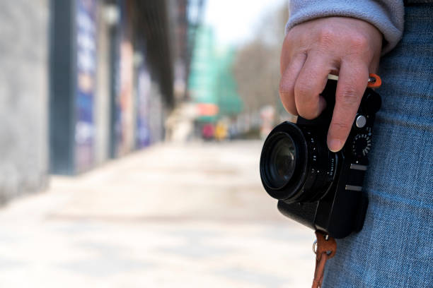 istock hand holding camera on street 663823766