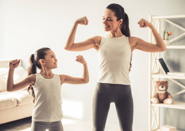 istock Mom and daughter working out 663827204