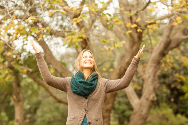 istock Smiling woman with arms raised 663827414