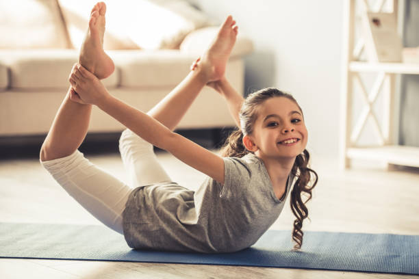 istock Little girl doing yoga 663827570