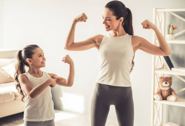 istock Mom and daughter working out 663827588
