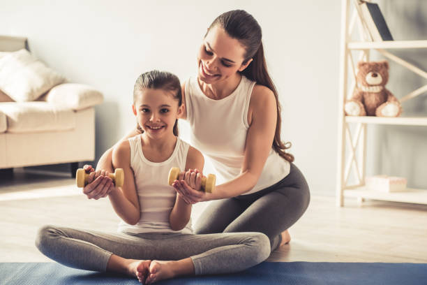 istock Mom and daughter working out 663827700
