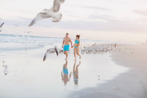 istock beautiful couple on the beach 663827992