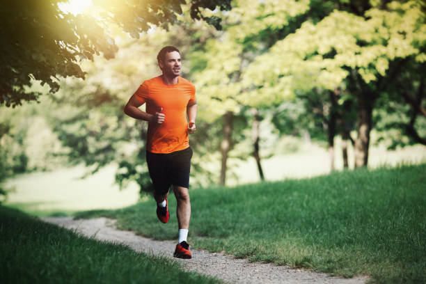 Active healthy runner jogging outdoor in nature Active healthy runner jogging outdoor in nature running jogging men human leg stock pictures, royalty-free photos & images