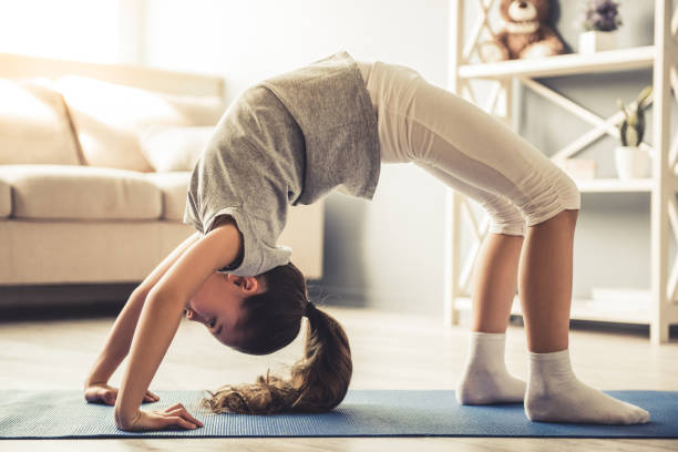 istock Little girl doing yoga 663828120