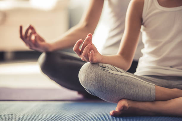istock Mom and daughter doing yoga 663830612