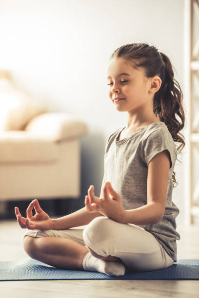 istock Little girl doing yoga 663830690