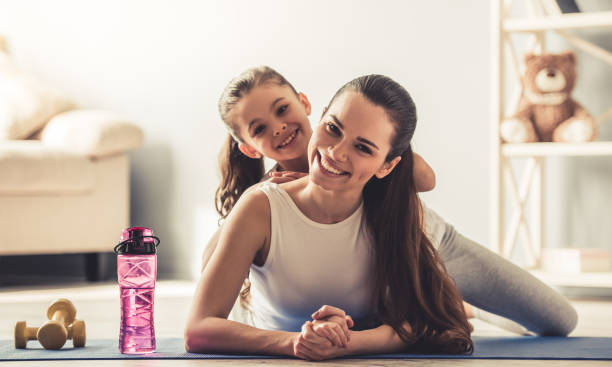 istock Mom and daughter doing yoga 663830764