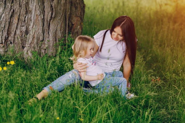 istock child near tree with mom 663834266