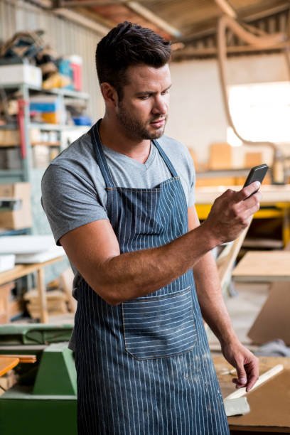 istock carpenter on the phone 663834292