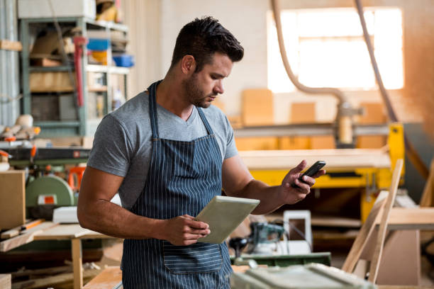 istock Carpenter on the phone 663834534