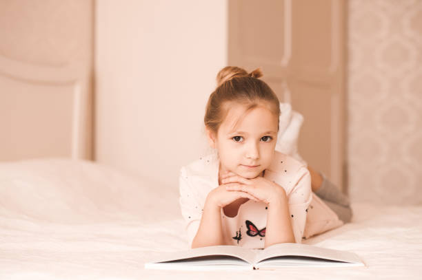 istock Girl reading indoors 663835048