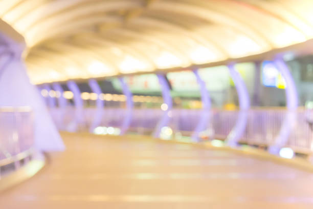 istock Blur Walkways, overpass between buildings with people walk at night, blur abstract background 663837328