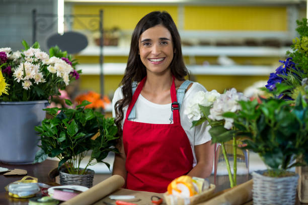 istock Smiling florist standing at the counter 663838322