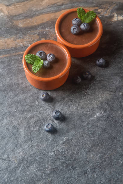 istock Chocolate mousse with berries in a ceramic bowl. Grey dark background. 663838772