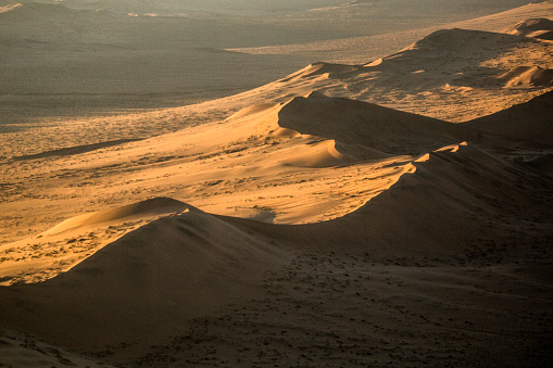 Large sand dunes in a desert from the air