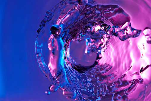 Abstract water rippled surface wallpaper. Liquid blue and pink macro clean texture