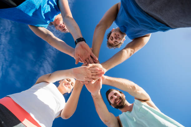istock Friends putting their hands together 663842372
