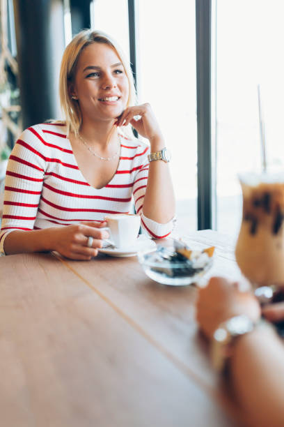 istock Beautiful women drinking coffee and gossiping in nice restaurant 663842740