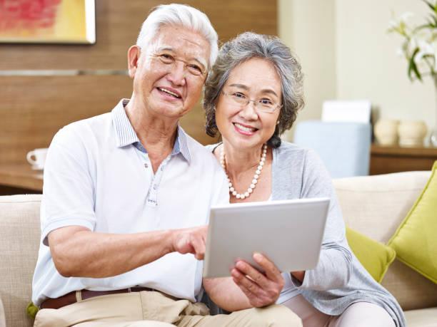 istock happy senior asian couple using digital tablet 663842952