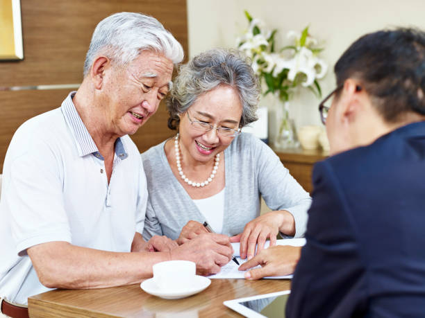 istock senior asian couple signing a contract 663845180